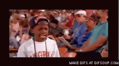 A Boy Wearing A Hat That Says Atlanta Is Sitting In A Crowd GIF