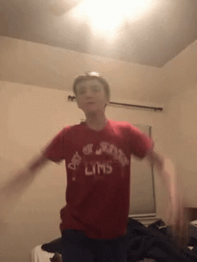 A Boy Wearing A Red Shirt That Says Day Of The Limbs On It GIF