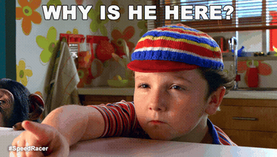 A Boy Wearing A Striped Hat Is Pointing At The Camera With The Caption " Why Is He Here " Above Him GIF