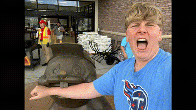 A Boy Wearing A Texans Shirt Stands In Front Of A Statue GIF