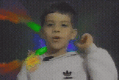 A Boy Wearing A White Adidas Sweatshirt Is Making A Funny Face GIF