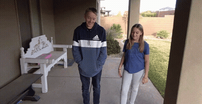 A Boy Wearing An Adidas Sweatshirt Stands Next To A Girl On A Porch GIF