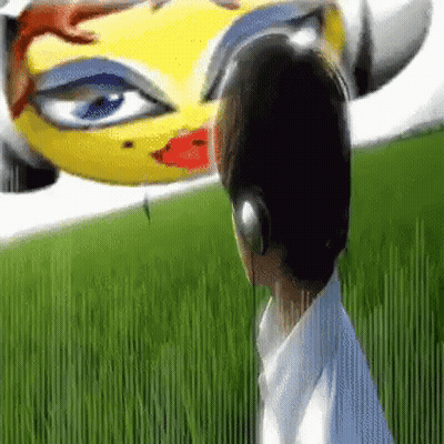 A Boy Wearing Headphones Is Standing In Front Of A Yellow Car With A Big Eye . GIF