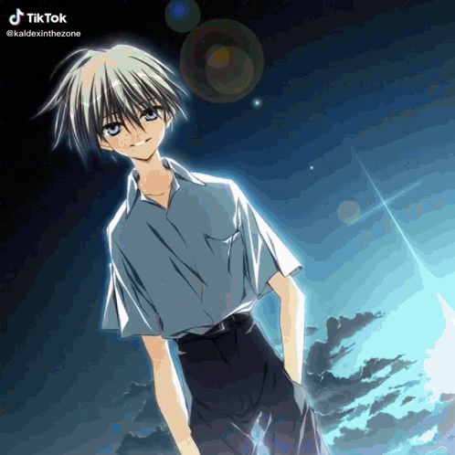 A Boy With A Blue Shirt And Black Shorts Stands In Front Of A Cloudy Sky GIF