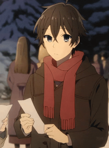A Boy With A Scarf Around His Neck Holds A Piece Of Paper In His Hand GIF
