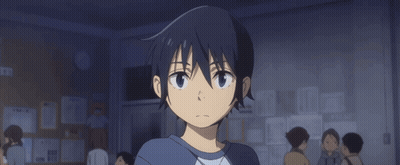 A Boy With A Surprised Look On His Face Is Standing In Front Of A Bulletin Board GIF
