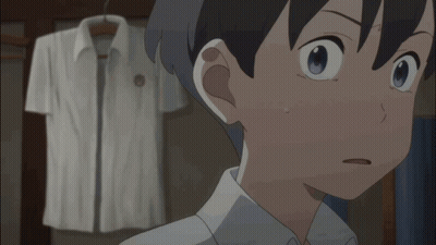 A Boy With A Surprised Look On His Face Stands In Front Of A White Shirt Hanging On A Rack GIF