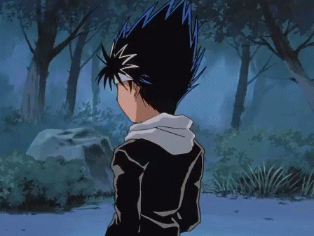 A Boy With Blue Hair Is Standing In A Forest GIF