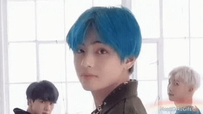 A Boy With Blue Hair Is Standing In Front Of A Window . GIF