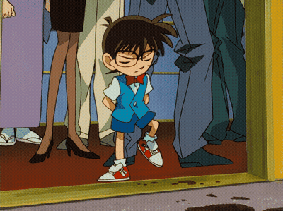 A Boy With Glasses And A Bow Tie Is Standing In A Crowd GIF