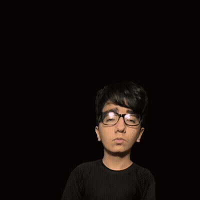 A Boy With Glasses Is Standing In Front Of A Pink Letter F On A Pink Background GIF