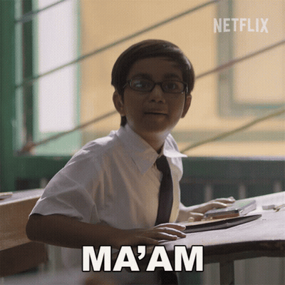 A Boy With Glasses Sits At A Desk With The Word Ma Am Above Him GIF