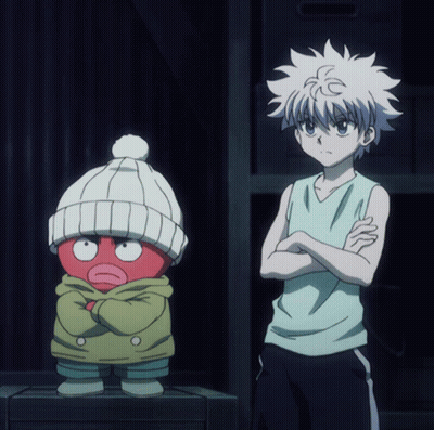 A Boy With His Arms Crossed Is Standing Next To A Red Cartoon Character GIF