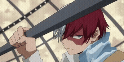 A Boy With Red Hair And Blue Eyes Is Holding A Bat Over His Head GIF