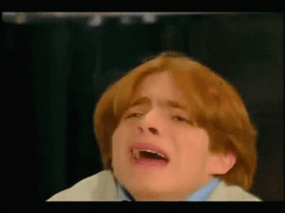 A Boy With Red Hair Is Crying With His Mouth Open GIF