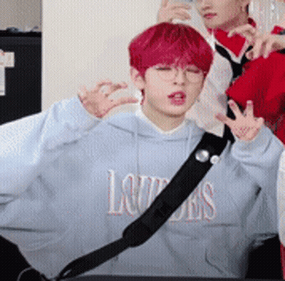 A Boy With Red Hair Is Wearing A Blue Hoodie That Says Louis On It . GIF