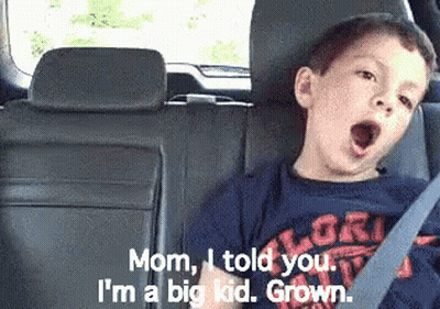 A Boy Yawning In The Back Seat Of A Car GIF