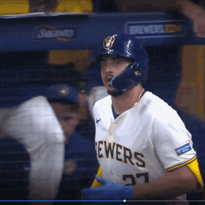A Brewers Baseball Player Wearing A Helmet And Number 27 GIF