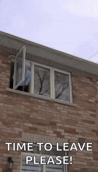A Brick Building With A Window That Is Open And Says `` Time To Leave Please '' . GIF
