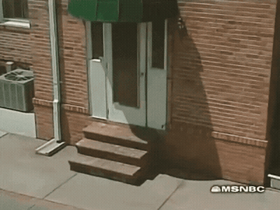 A Brick Building With Stairs And A Green Awning Says Msnbc GIF