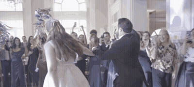A Bride And Groom Are Dancing At Their Wedding Reception GIF