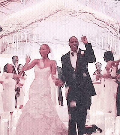 A Bride And Groom Are Dancing In Front Of A Crowd At Their Wedding GIF