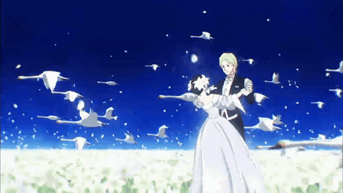 A Bride And Groom Are Dancing In Front Of A Flock Of Swans GIF
