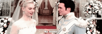 A Bride And Groom Are Holding Hands At Their Wedding And The Bride Is Talking To The Groom . GIF
