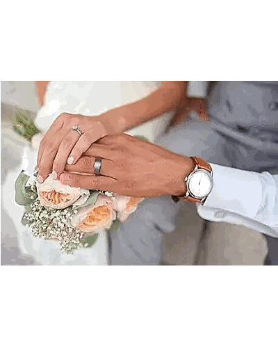 A Bride And Groom Are Holding Hands With Their Wedding Rings On . Sticker