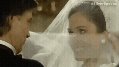 A Bride And Groom Are Looking Into Each Other 'S Eyes . GIF