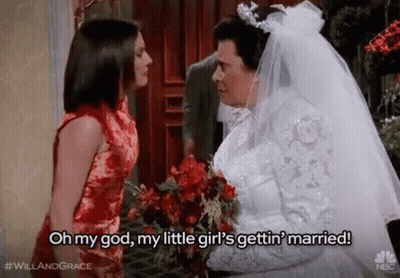 A Bride And Groom Are Standing Next To Each Other And The Bride Is Holding A Bouquet Of Flowers . GIF