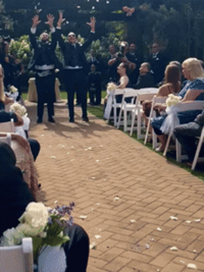 A Bride And Groom Are Walking Down The Aisle At Their Wedding Ceremony GIF