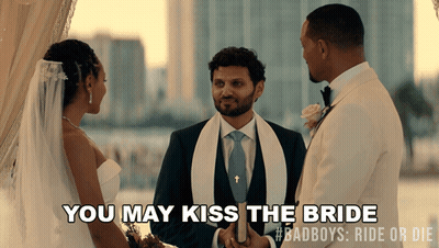 A Bride And Groom At Their Wedding Ceremony With The Words You May Kiss The Bride GIF