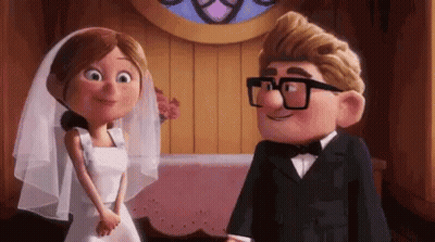 A Bride And Groom From Up Are Standing Next To Each Other And Smiling At Each Other . GIF