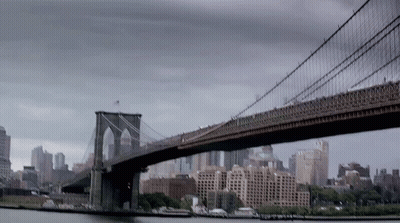 A Bridge Over A Body Of Water In A City GIF