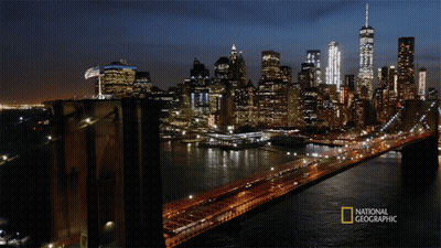 A Bridge Over A Body Of Water With A National Geographic Logo On The Bottom GIF