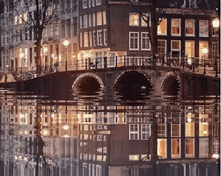A Bridge Over A Body Of Water With A Reflection Of Buildings In The Water GIF