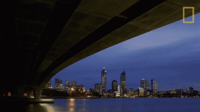 A Bridge Over A Body Of Water With The National Geographic Logo In The Corner GIF