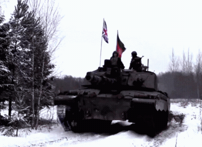 A British Flag Is Flying From The Top Of A Military Vehicle GIF
