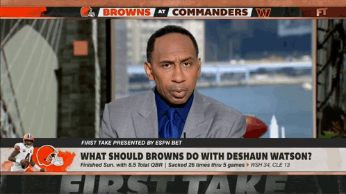 A Broadcast Of The Browns At Commanders With A Man In A Suit On The Screen GIF