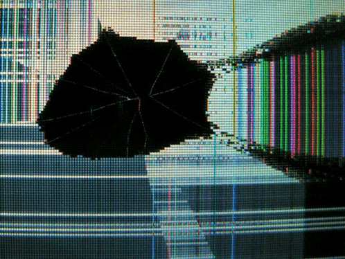 A Broken Computer Screen With A Black Umbrella In The Middle Of It GIF