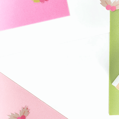 A Brown Envelope With A Pink Ribbon Tied Around It GIF