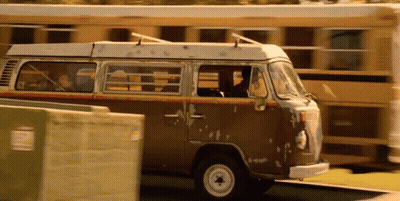 A Brown Van Is Parked In Front Of A Yellow School Bus GIF