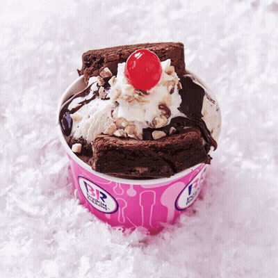 A Brownie Sundae With A Cherry On Top In A Pink Baskin Robbins Cup GIF