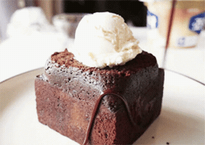 A Brownie With A Scoop Of Ice Cream On Top Of It GIF