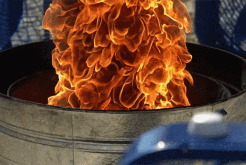 A Bucket Of Flames Coming Out Of It GIF