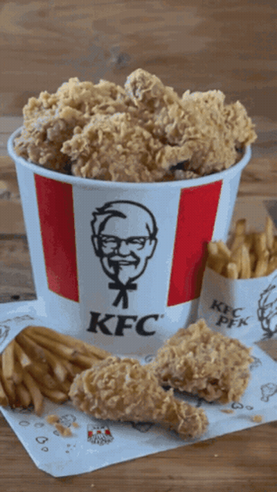 A Bucket Of Kfc Fried Chicken And French Fries On A Table GIF