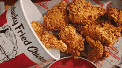 A Bucket Of Kfc Fried Chicken Sits Next To A Pile Of Fried Chicken GIF