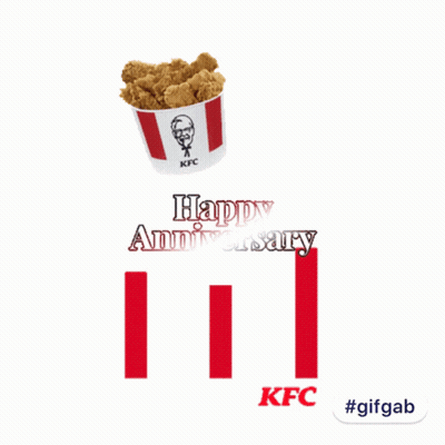 A Bucket Of Kfc Fried Chicken Sits On Top Of A Happy Anniversary Sign GIF