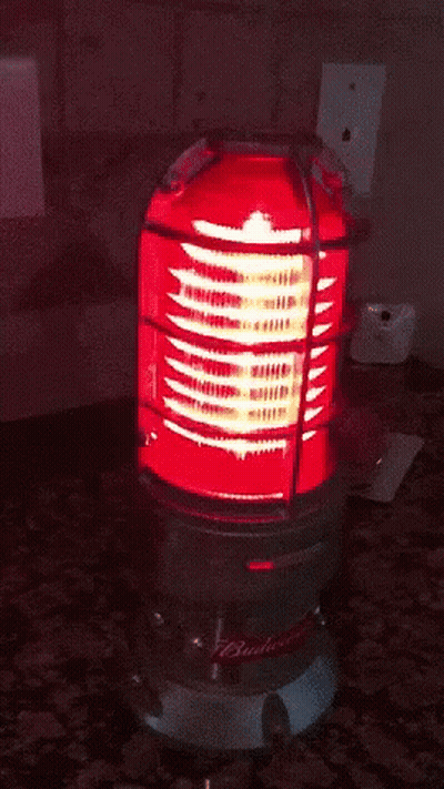 A Budweiser Light Is Lit Up On A Counter GIF